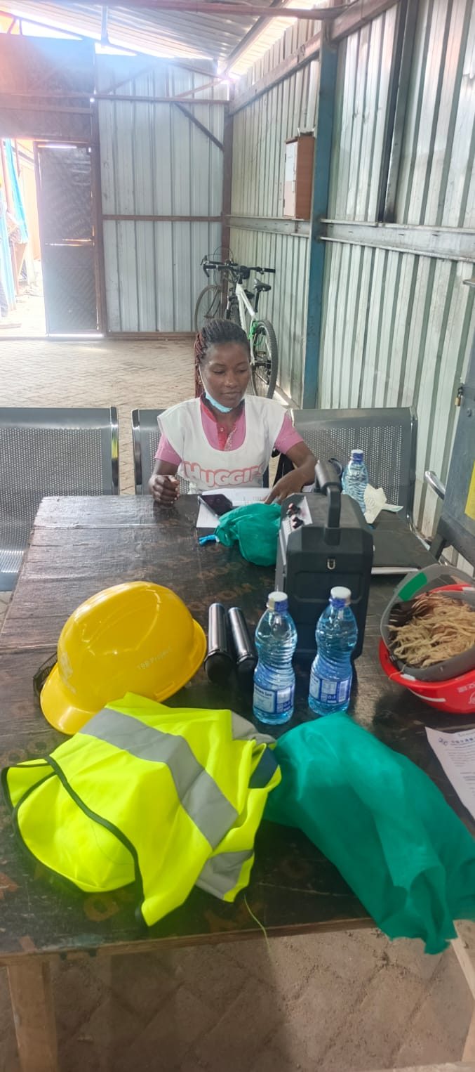 Dagloda health worker with workplace health materials